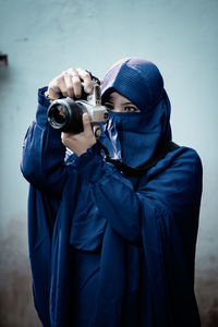 Close-up of man photographing through camera