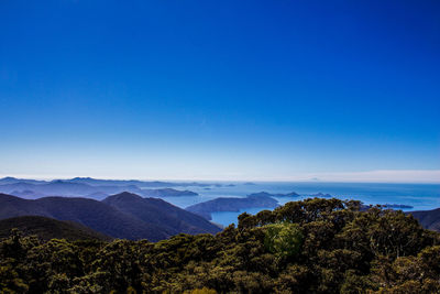 Scenic view of mountains against clear blue sky