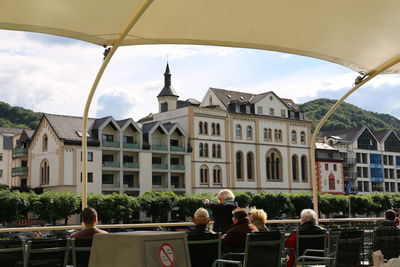 People in front of buildings against sky