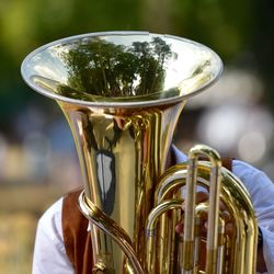 Close-up of musician with musical instrument standing outdoors