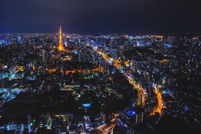 Aerial view of city lit up at night