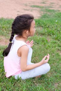 Young woman sitting on field