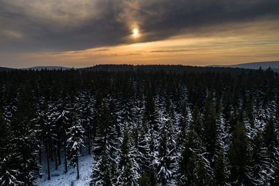 Scenic view of snowy landscape against sky during sunset