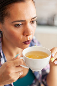 Close-up of young woman having drink