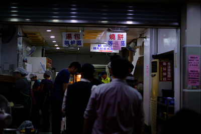 Rear view of people in city at night