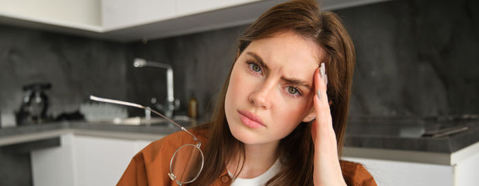 Portrait of young woman sitting at home