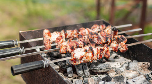 Marinated shashlik preparing on barbecue grill over charcoal. shashlik or shish kebab in europe