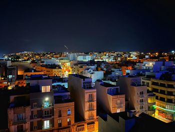 High angle view of illuminated buildings in city at night