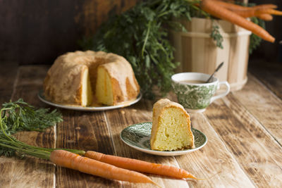 Sugar glazed carrot cake, homemade baked goods, rustic still life, national carrot cake day, cup 