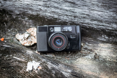 Close-up of vintage camera on wood