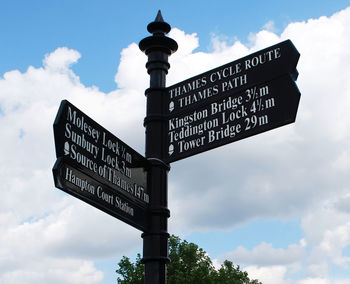 Low angle view of information sign against sky