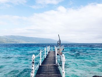 Jetty leading to calm sea