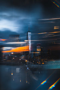 Aerial view of illuminated city against sky at night