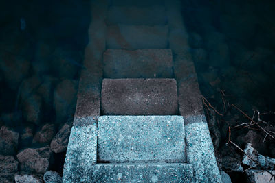 High angle view of stones by stone wall