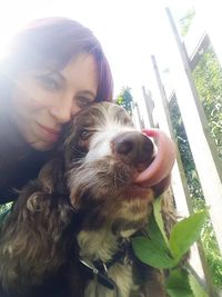 Portrait of young woman with dog