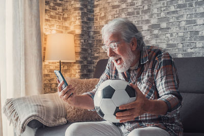 Man playing soccer at home
