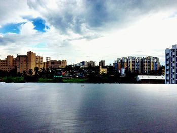 Cityscape against cloudy sky