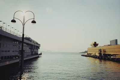 Scenic view of sea by buildings against clear sky