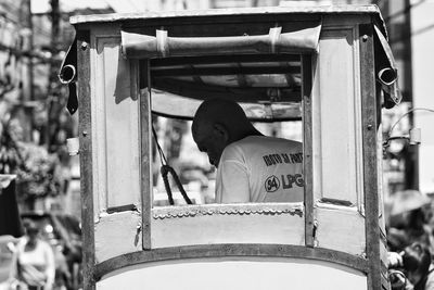 Rear view of man traveling in bus