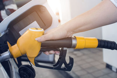 Close-up of hand holding yellow camera