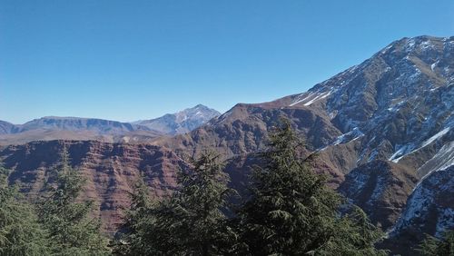 Scenic view of mountains against clear blue sky