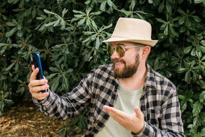 Portrait of young man using mobile phone