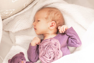 High angle view of baby boy sleeping on bed at home