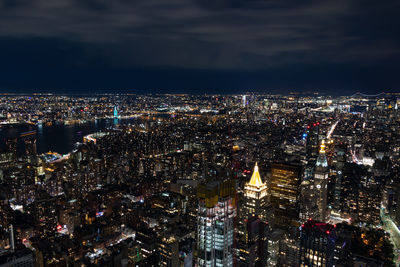 High angle view of illuminated city buildings at night