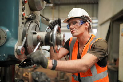 Portrait of male worker standing in the heavy industry manufacturing factory.