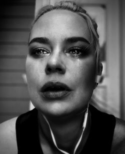 Close-up portrait of woman at home crying 