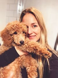 Portrait of smiling woman carrying dog