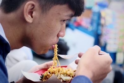 Close-up of man eating food