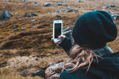 Rear view of woman photographing