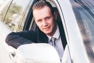 Portrait of businessman driving car