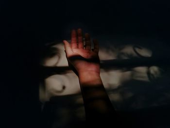 Close-up of human hand in darkroom