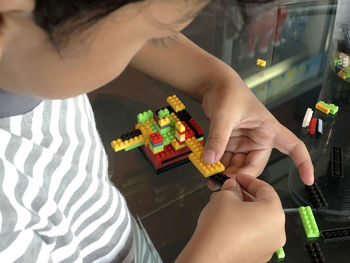 Close-up of boy playing with toy blocks at home