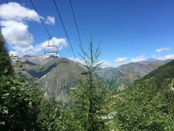 Scenic view of mountains against blue sky