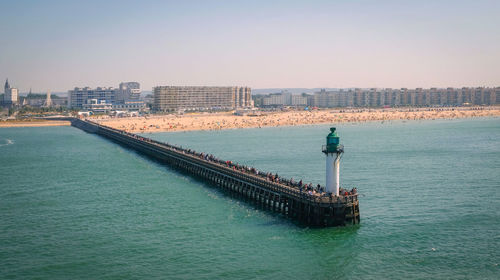 Pier over sea against clear sky