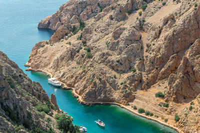 High angle view of rocks on sea shore