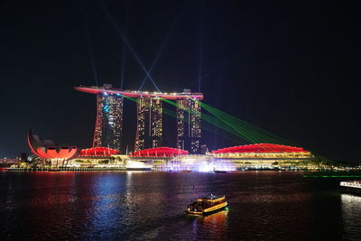 Illuminated city at waterfront