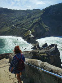 Rear view of woman looking at sea shore