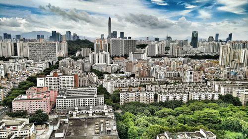 Cityscape against cloudy sky