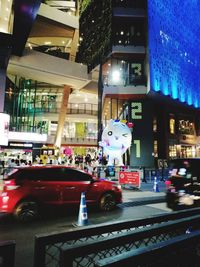 Vehicles on road in city at night