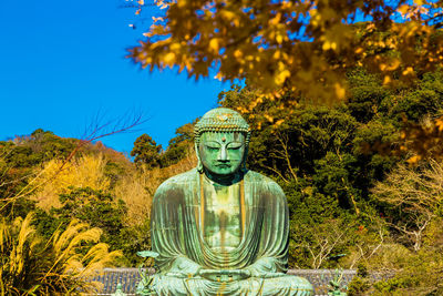 Statue against blue sky