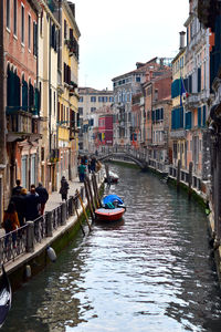 Boats in canal with buildings in background