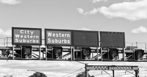 Low angle view of information sign against sky