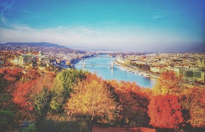 High angle view of river amidst trees against sky