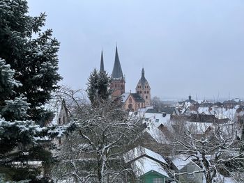 Panoramic view of trees and buildings against sky during winter