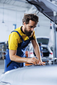 Side view of man working at gym