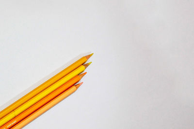 Close-up of yellow pencils against white background